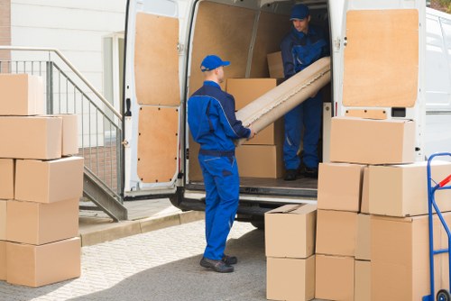 Student moving van near an Islington residential street with boxes being loaded