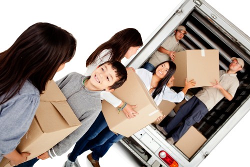 Moving team loading boxes into a removal van during a house move