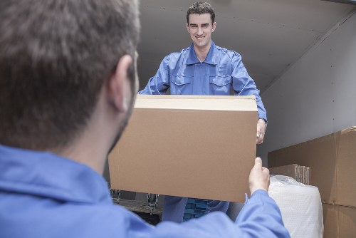 Removal van and movers preparing a house move on an Islington street