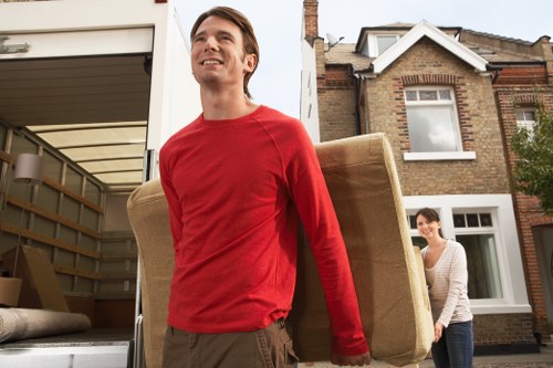 Furniture being carried through a narrow stairwell in an Islington flat