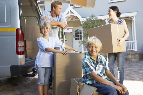 Local movers navigating a residential street in Islington with furniture and boxes